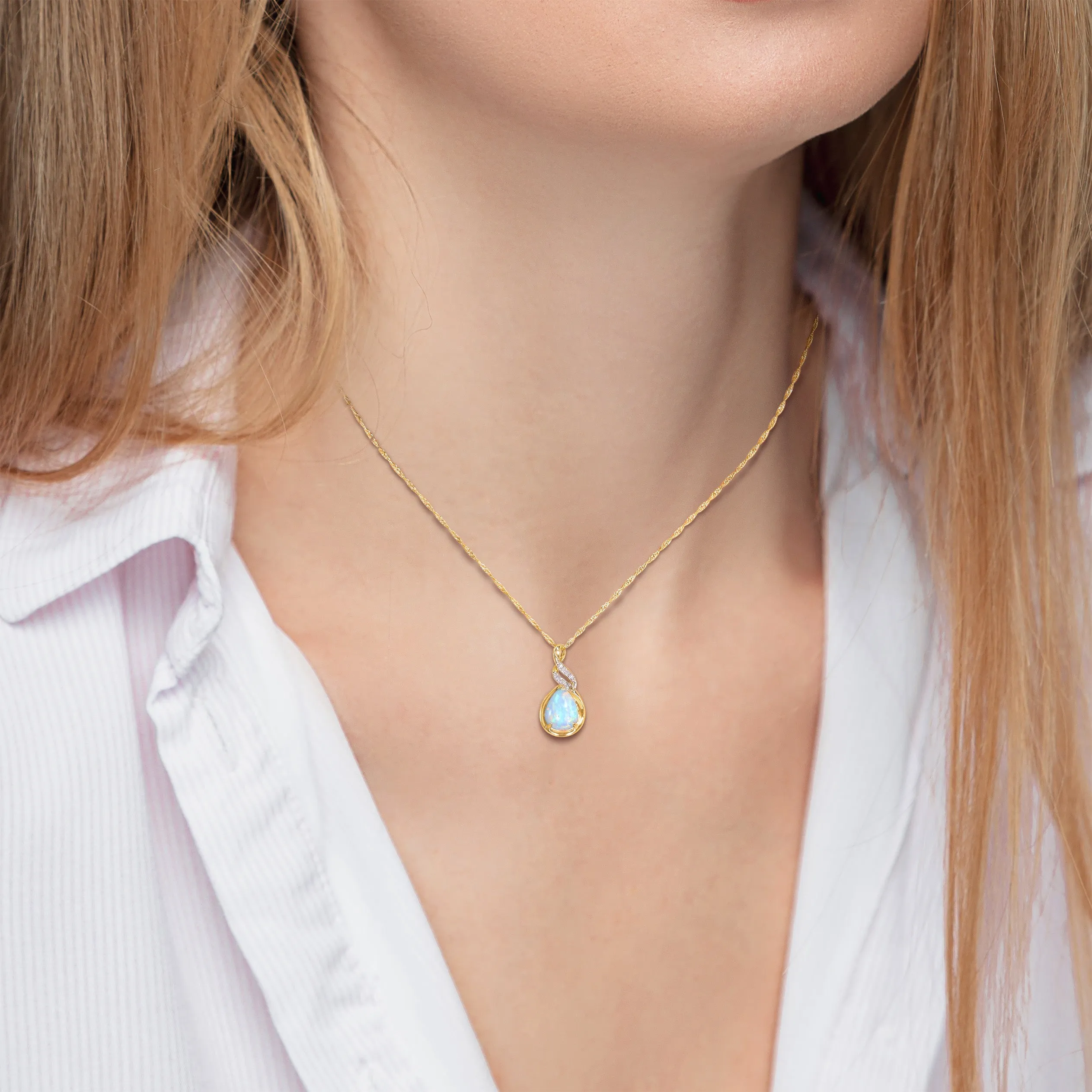 1 1/5 CT TGW Ethiopian Blue Opal and Diamond Accent Twist Pendant with Chain in 10K Yellow Gold